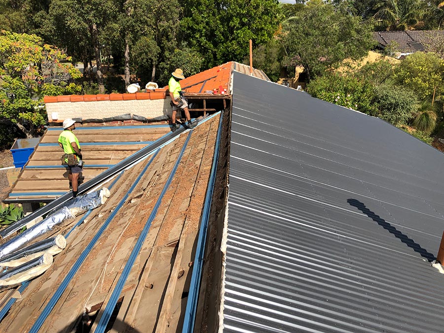 Perth roof experts on top of a roof providing maintenance services including carpentry and repair for tiles, metal roofs and timber sagging etc.
